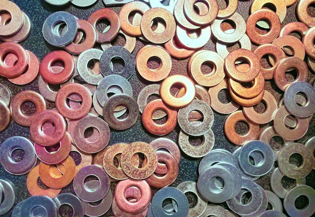 Assorted colored washers piled on a flat surface