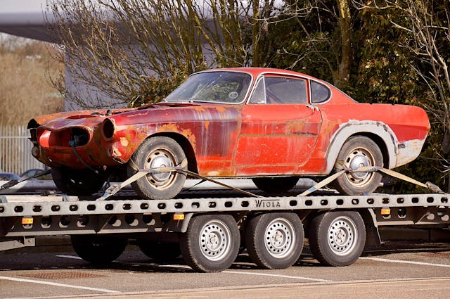  Car on a trailer held down by cables