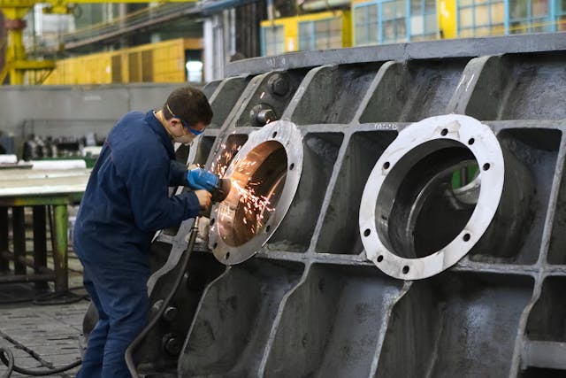 Man performing metal work with tools